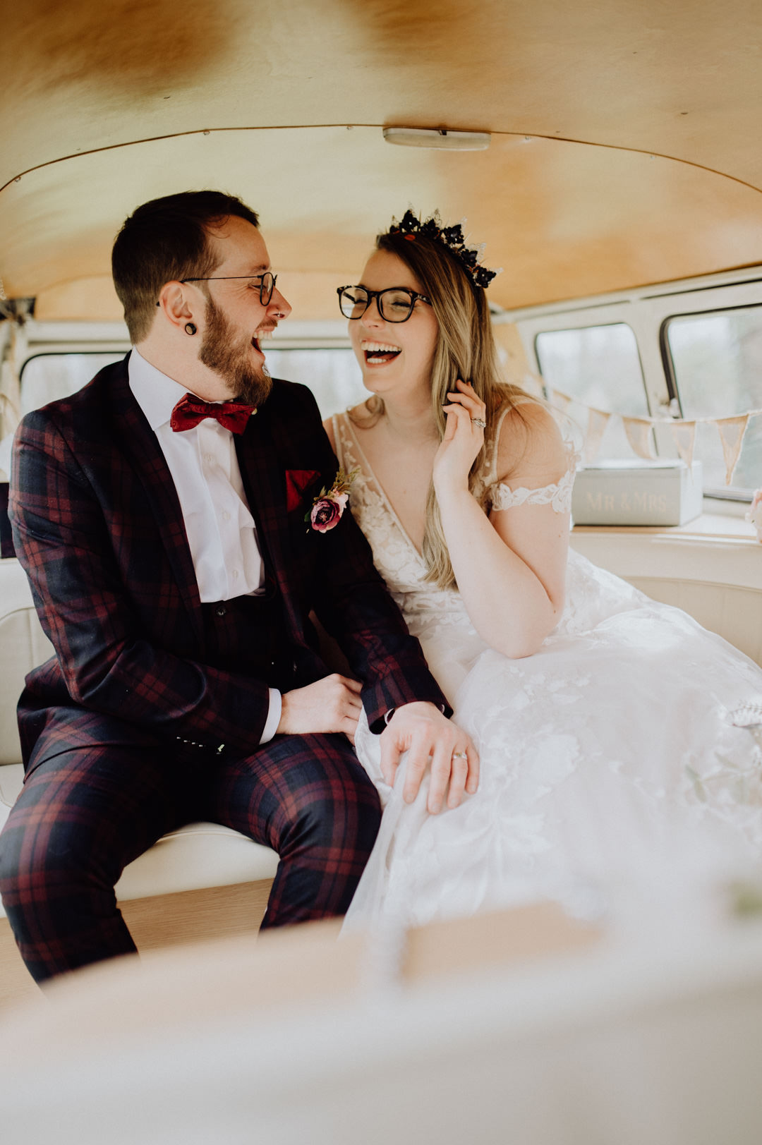 bride and groom kissing in classic camper van