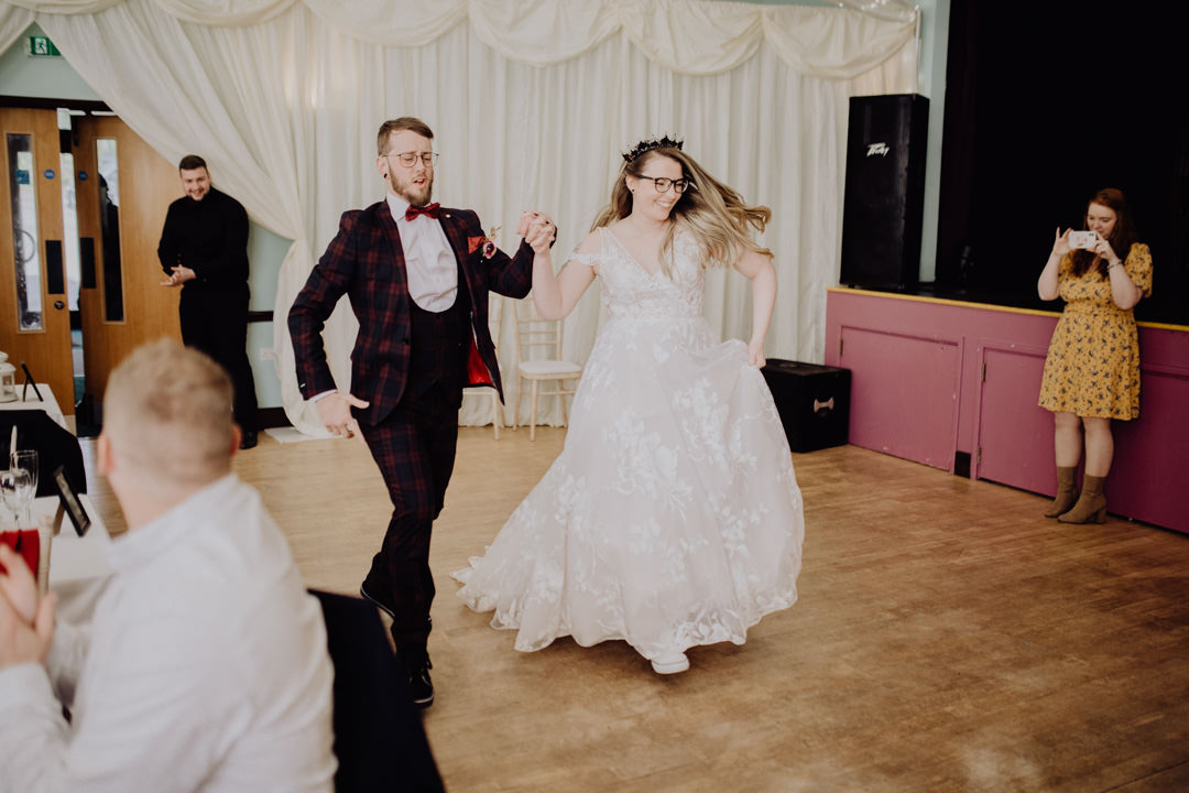 bride and groom dancing in large hall