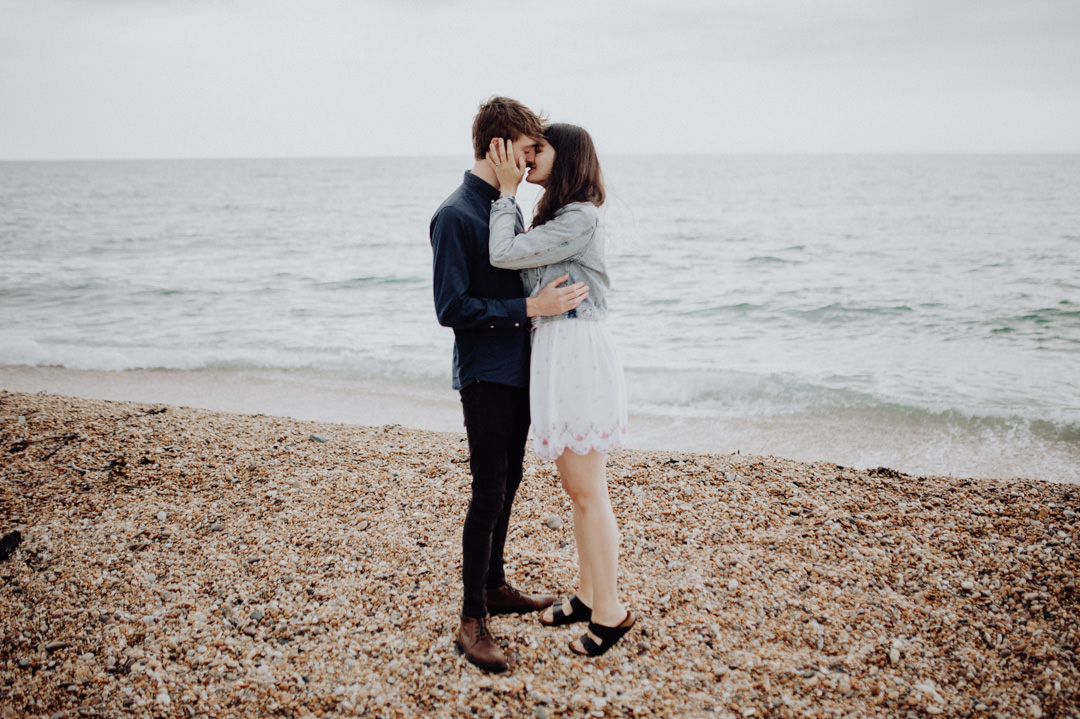 man and woman on beach kissing