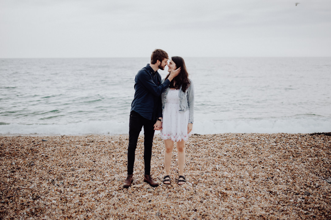young couple on beach kissing
