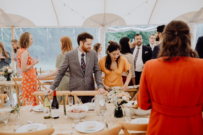 wedding guests in large festival tent during daytime
