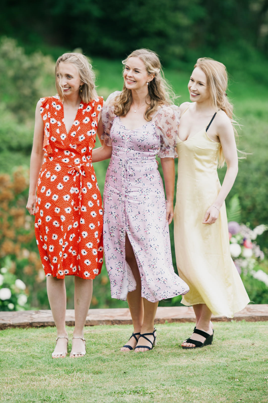 girls in dresses at wedding party in large garden