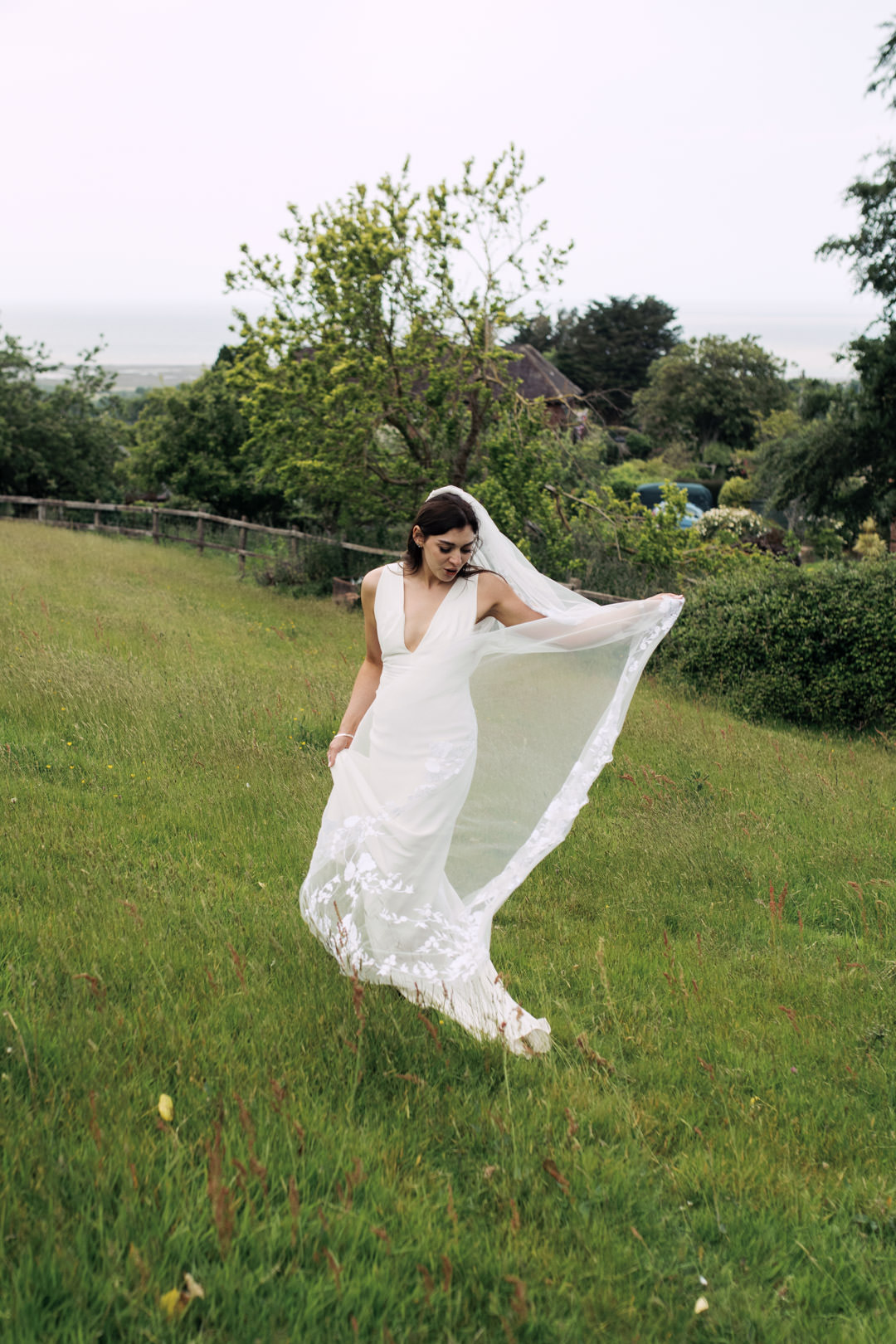 bride waring white dress in meadow field