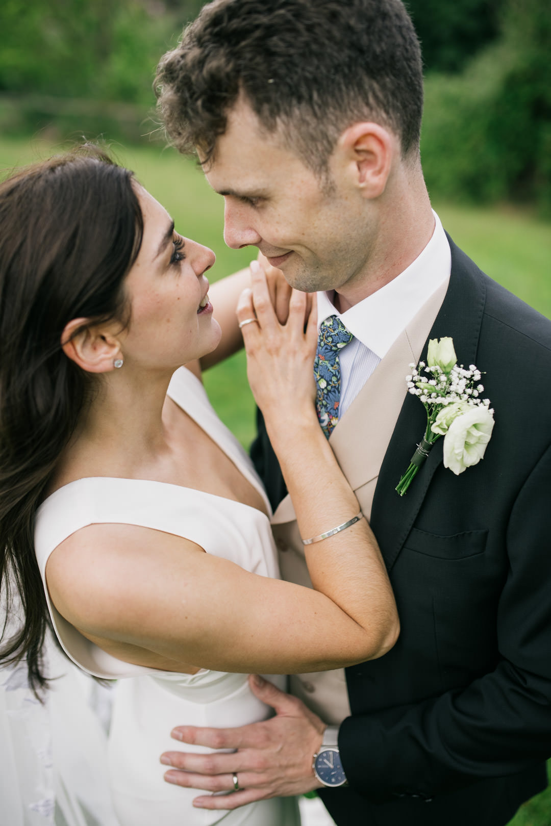 bride and groom kissing in meadow