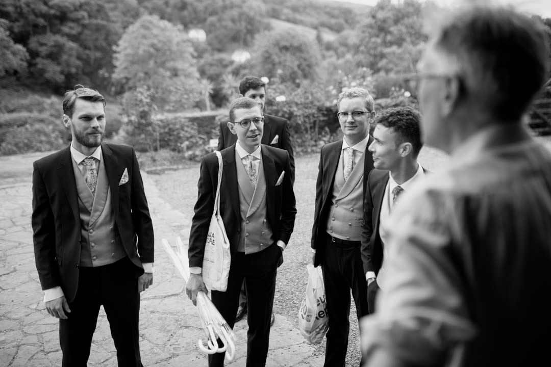 groomsmen at wedding waring black suits