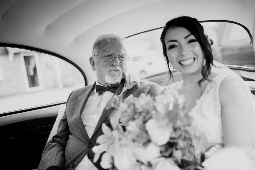 bride and father sat in classic car