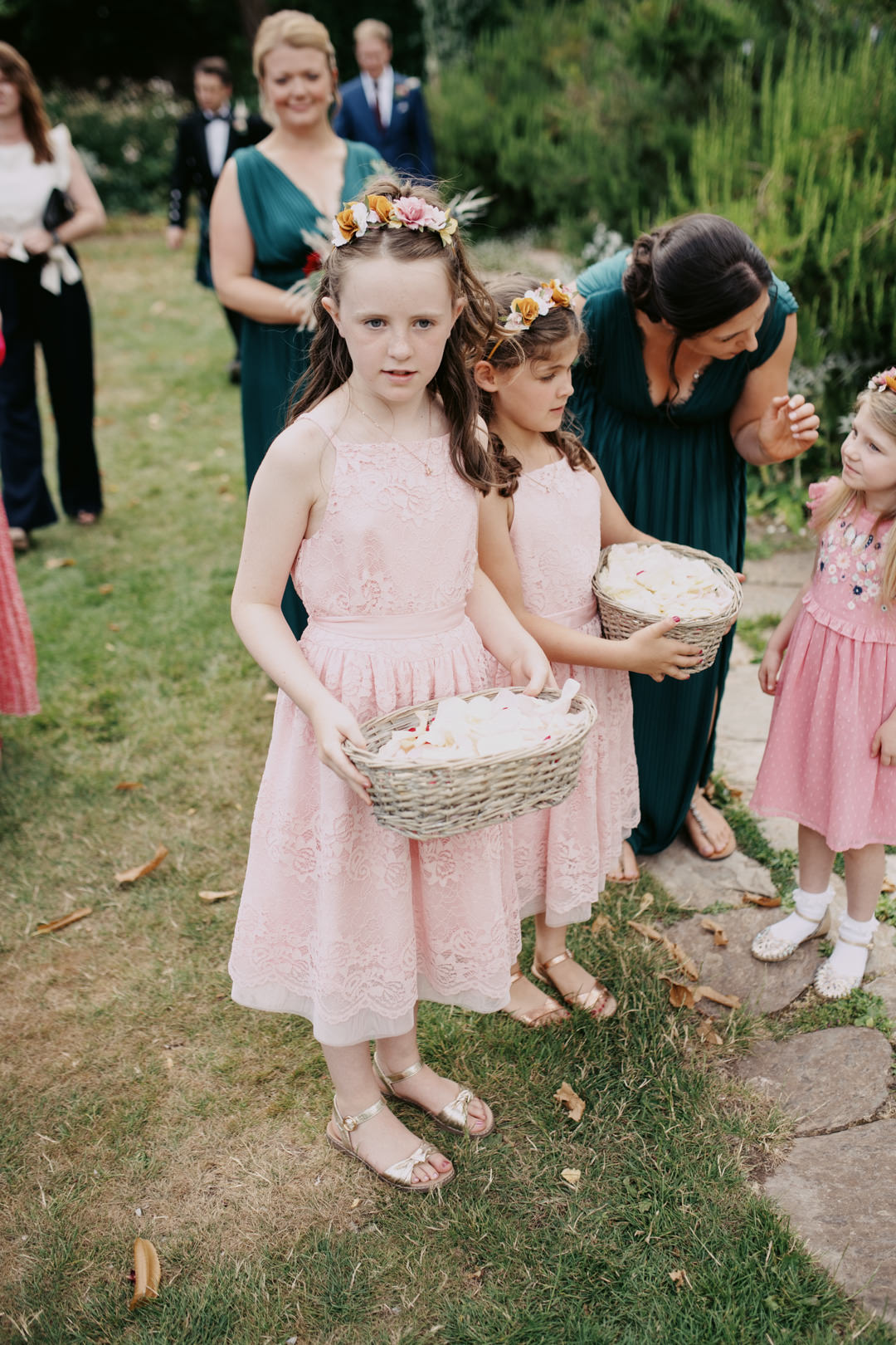 young girl in pink dress waring flower crown