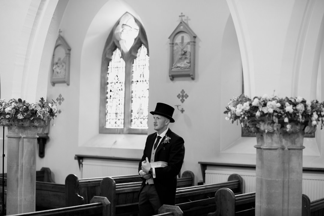 man waring top hat in church