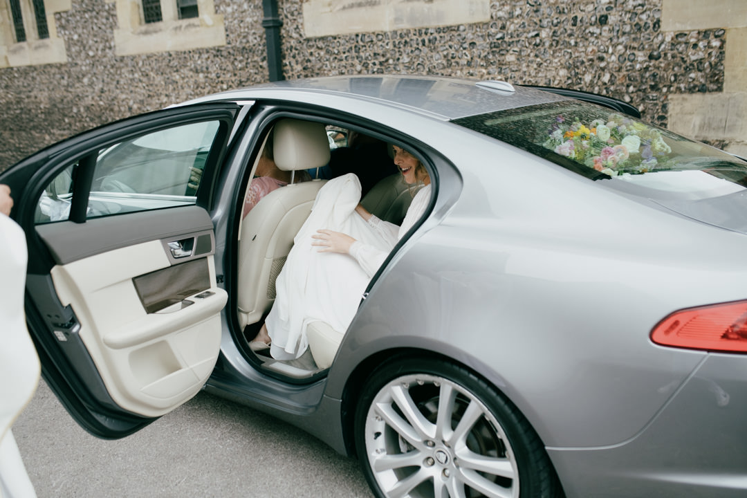 bride getting out of silver car
