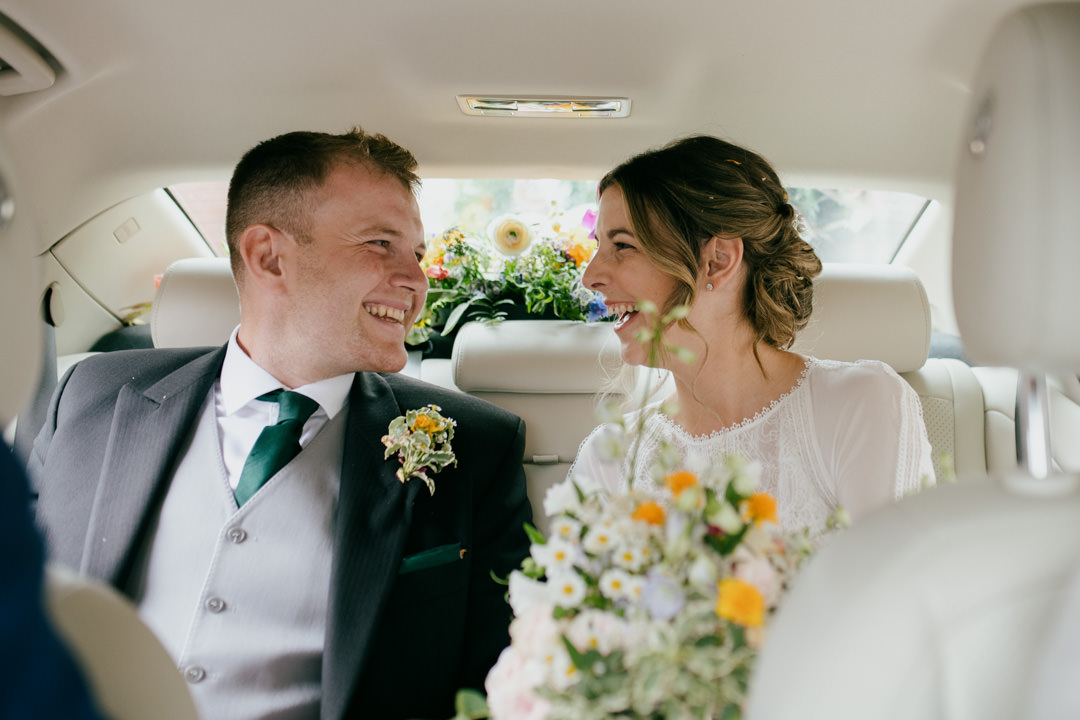 bride and groom sat in car