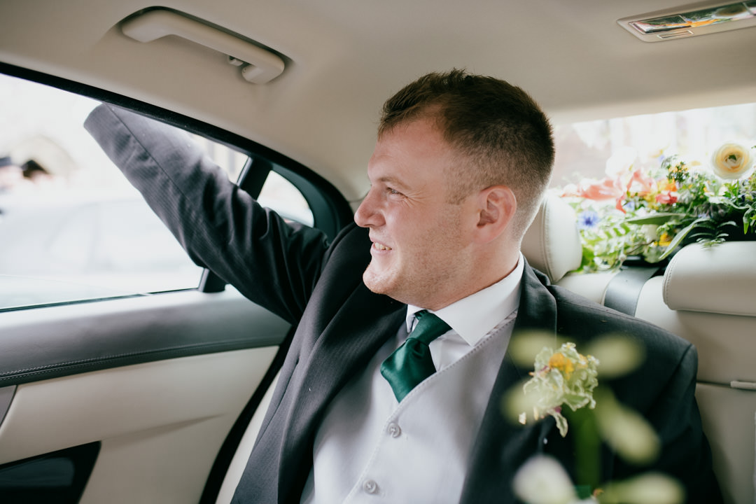 groom waving out of car window