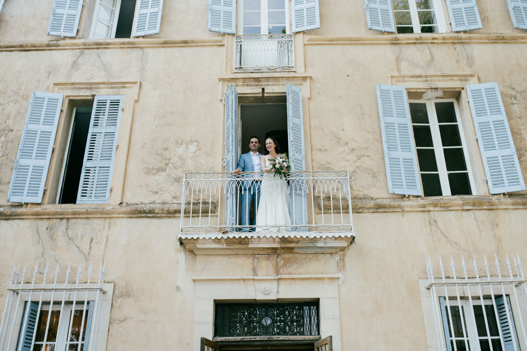 bride and groom stood on balcony