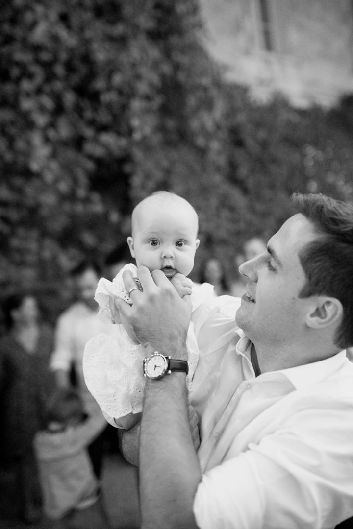 man holding baby at wedding