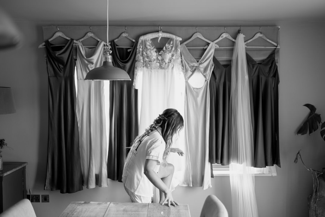bride hanging up wedding dress