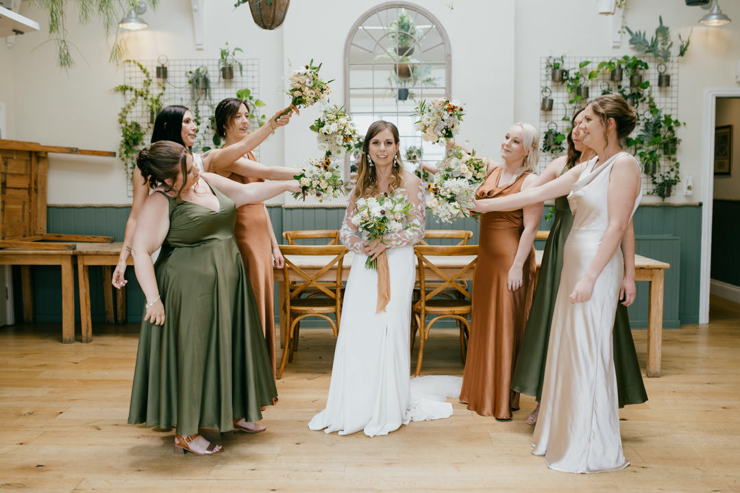 bridesmaids holding flowers in orangery