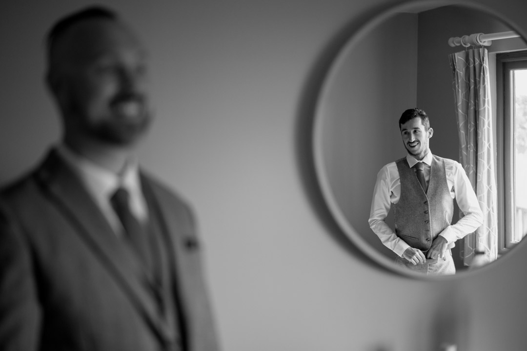 man in mirror reflection with suit on