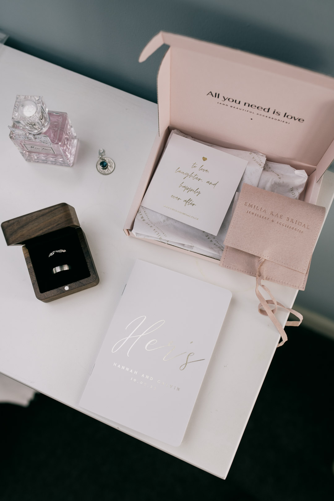 wedding rings and perfume on table