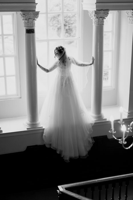 bride stood in large window crowcombe court
